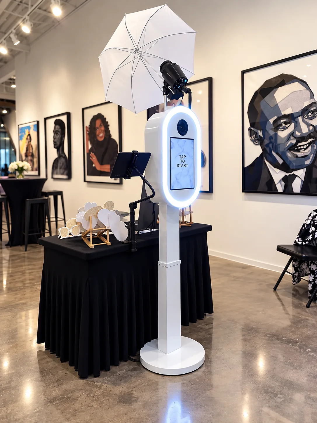 White CrafTea Details DSLR Glam Photo Booth with studio lighting and prop table in an art gallery venue