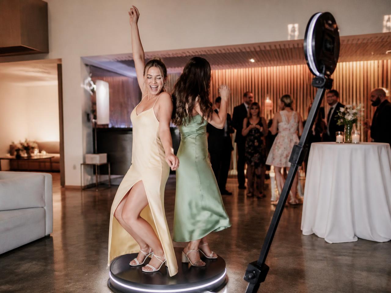 Guests dancing on a 360 video booth platform at a Houston celebration